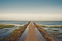 gravel road leading to a shore 