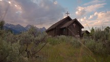 Old Wooden Chapel in the Mountains at Sunset