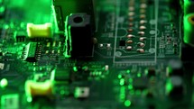 Circuit board with components background. Extreme close up of green electronic board, with electronic components.
