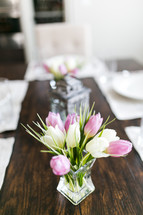 tulips in a vase on a set table for Easter 