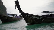small boat in thailand in the rain