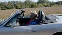 couple riding in a convertible 
