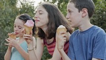 Kids eating Ice Cream together, enjoying and laughing