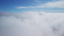 Aerial shot in the cloud. Soaring above the cloud celestial landscape