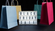 Black Friday composition with bags and Board 