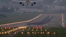 Airplane landing on a runway with lights