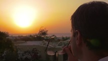 Man putting on spectacles to enjoy the sunset