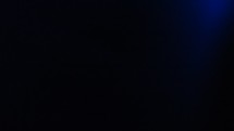 Pulsating blue light in in dark black blank copy space