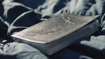 Young man reading his Bible outside on a warm sunny day