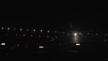 Airplane taxiing at night at an airport