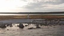 Lighthouse on an island during sunset