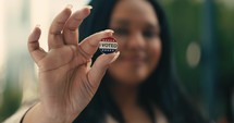 Young woman smiling with an ‘I Voted’ stickers and pin 