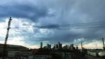 moving clouds over city buildings and power lines
