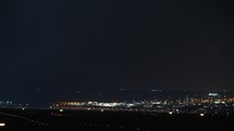 Aircraft night take-off. Airport lights in the dark