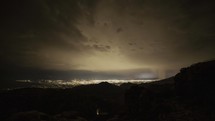 Timelapse of a thunderstorm over a city at night