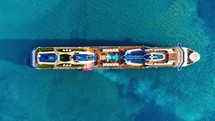 Summer holidays travel vacation concept. Cruise Ship, Cruise Liners beautiful white cruise ship Aerial view of the cruise ship in open water. Passenger cruise ship sailing in ocean top view from above. Large luxury cruise liner deck. above luxury cruise in the ocean sea. 
