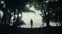 Young woman hiking in a tropical rainforest jungle 