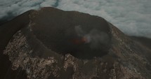 Smoke coming out of Fuego Volcano crater in Guatemala. - Aerial orbit	