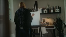 artist painting a canvas 