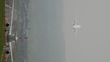 Time lapse vertical video of Swiss Airlines airplanes taking off a runway.