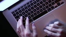 hands on a laptop computer 