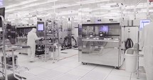 Semiconductor manufacturing facility with workers in clean suits