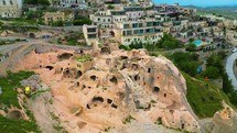 Aerial view of typical houses excavated and shaped into the mountains in Cappadocia region, Nevsehir, Turkey.
