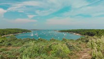 Drone flying towards bay with sailboats in Istria Croatia