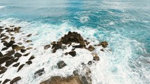 Crashing ocean waves into rocks 