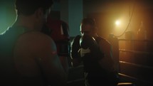 boxers fight in the ring at night