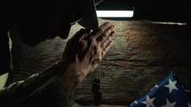 Soldier praying with hands folded on veterans day 