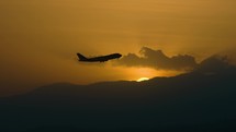 Silhouette Of Airplane Take Off At Sunset