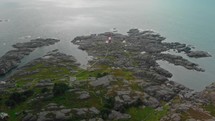 drone flies over lighthouse on norwegian south coast Eigeroy Fyr