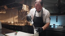 Chef prepares almond pesto with blender