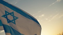 Israel Flag waving on sunset sky