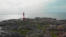 drone flies over lighthouse on norwegian south coast Eigeroy Fyr
