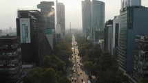 Vehicles Passing Between Modern Buildings In Mexico City - aerial drone shot	