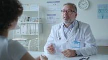 Doctor Providing Medical Advice and Shaking Hands with Patient in Clinic
