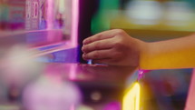 Little girl is playing games at the amusement park
