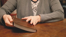 a woman sitting down to read a Bible 