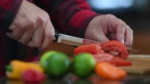 a man cutting tomatoes 