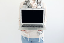 a woman holding a laptop computer 