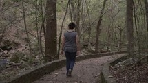 a woman walking on a path 