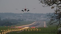Airplane landing on lit up runway