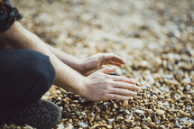 person playing with pebbles 