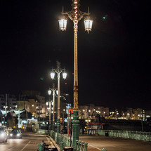 glowing street lights by a harbor at night 
