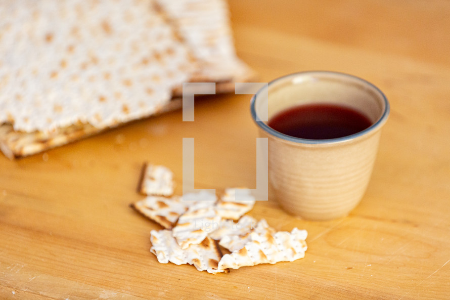 Cup of juice with broken matzah crackers