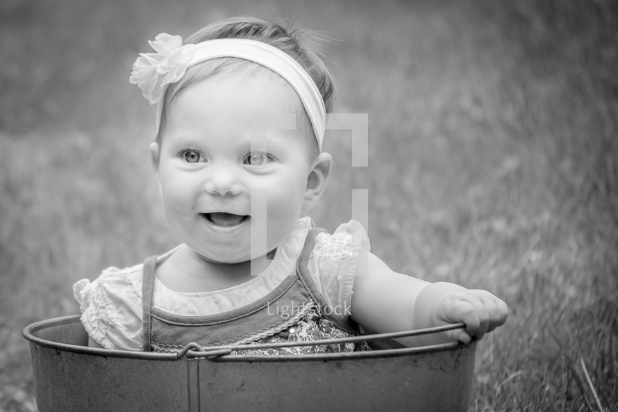 an infant in a bucket 