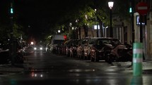 Cars with headlights turning down city street
