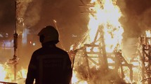 Fireman controls the bonfire of Las Fallas festival in Spain